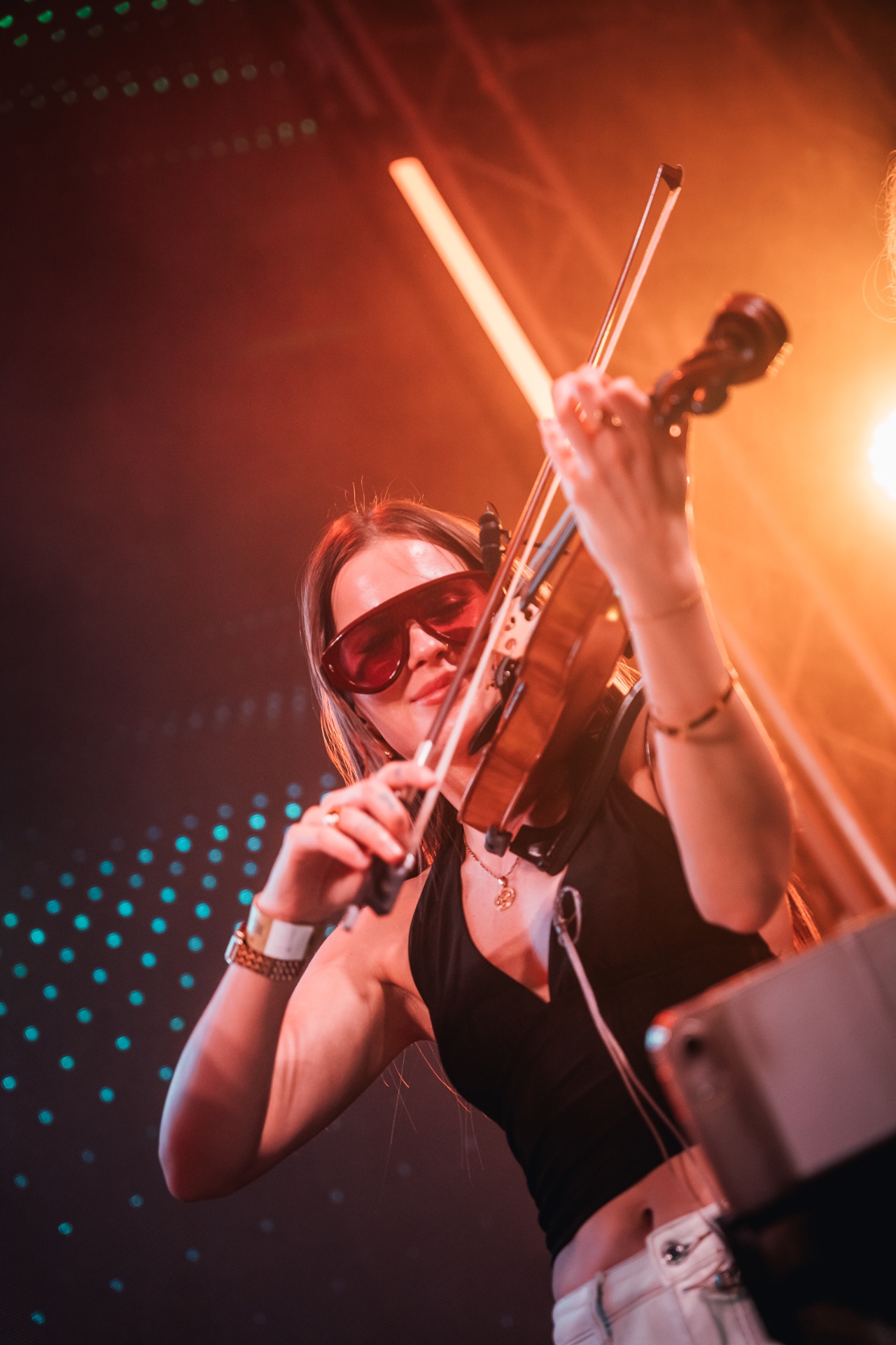 Violinist under warm stage light